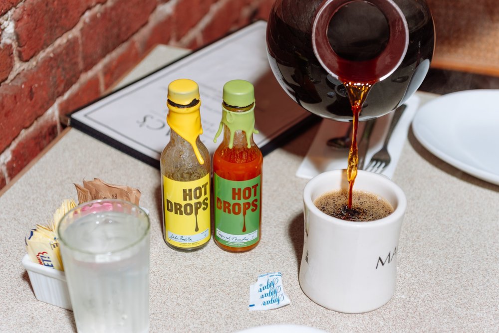 Hot Drops bottles on a diner table
