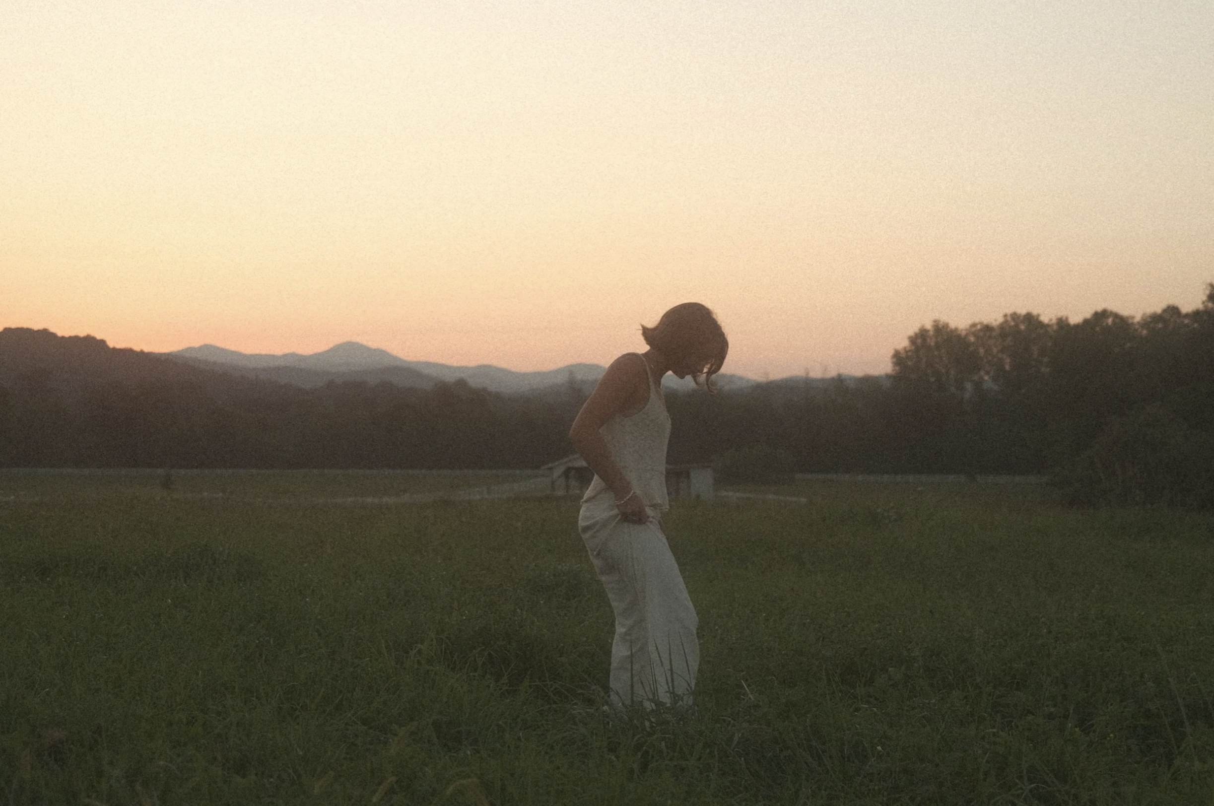Guest walking through the field at dusk