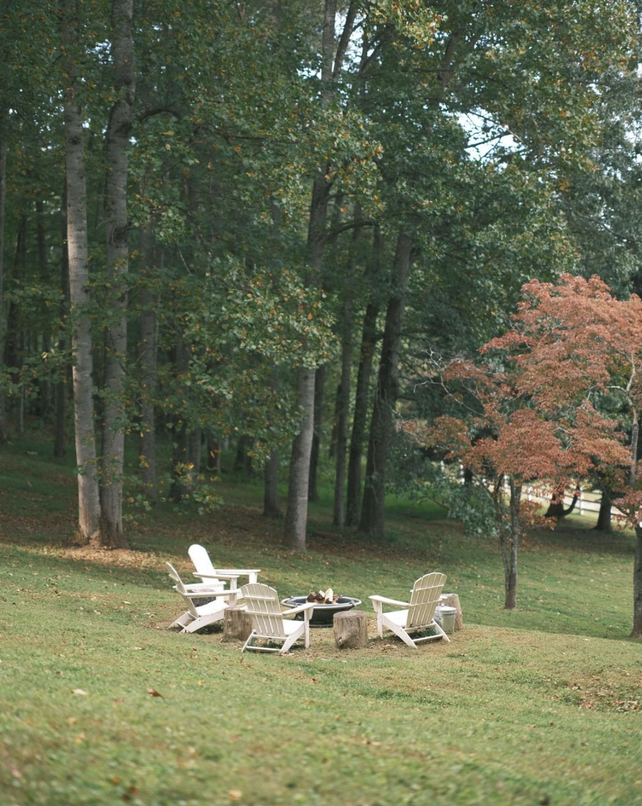 Adirondack chairs around a fire pit