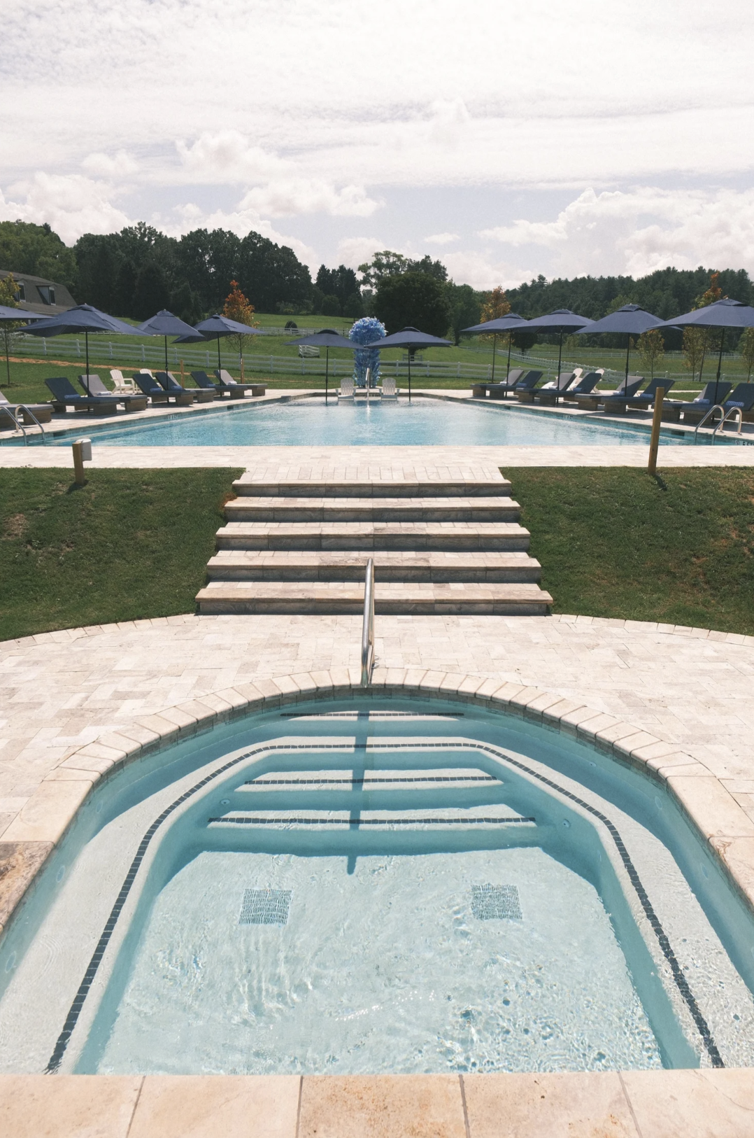 The hot tub leading up to the pool