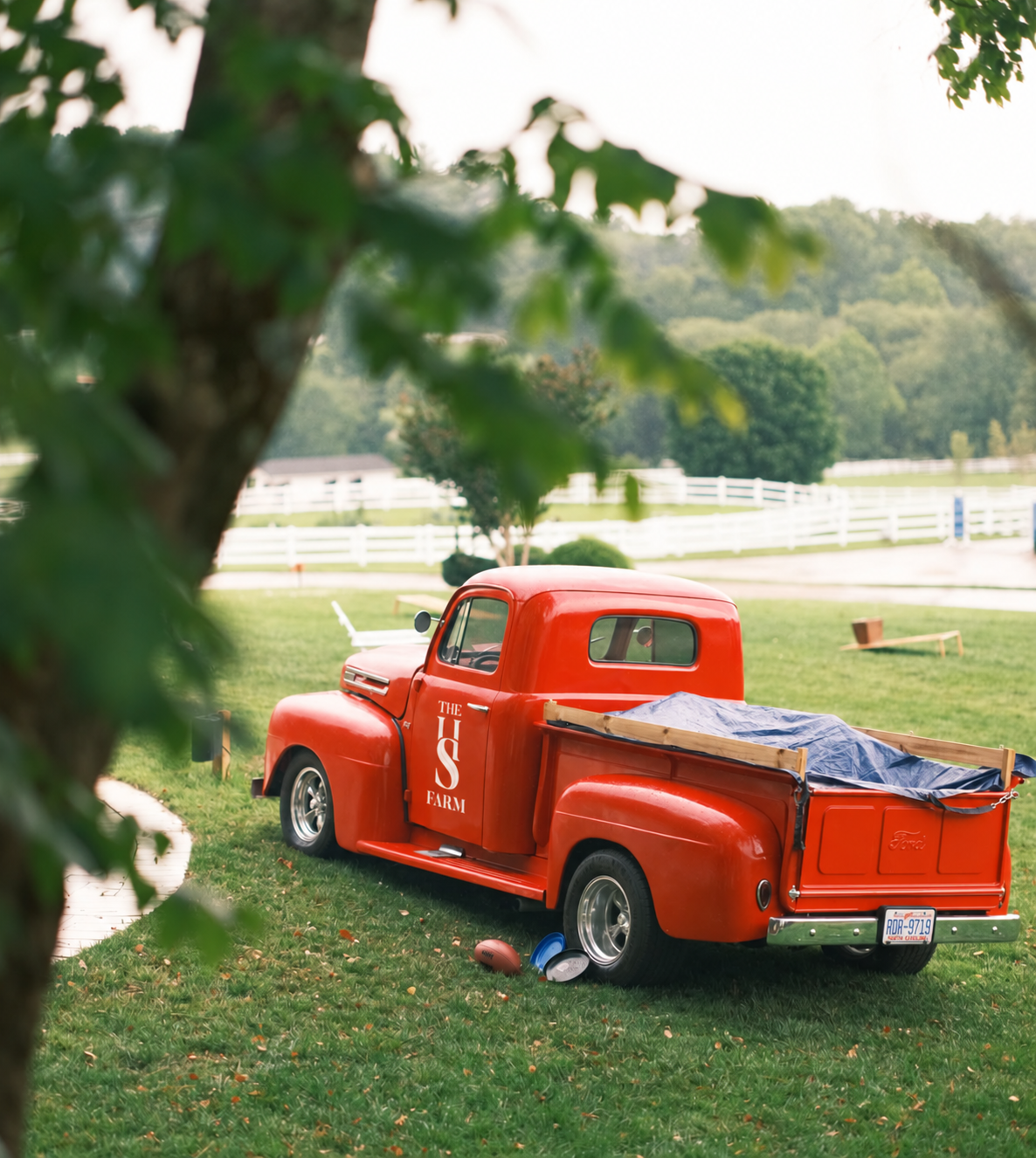 Red pickup truck with the HS Farm vertical logo on the door