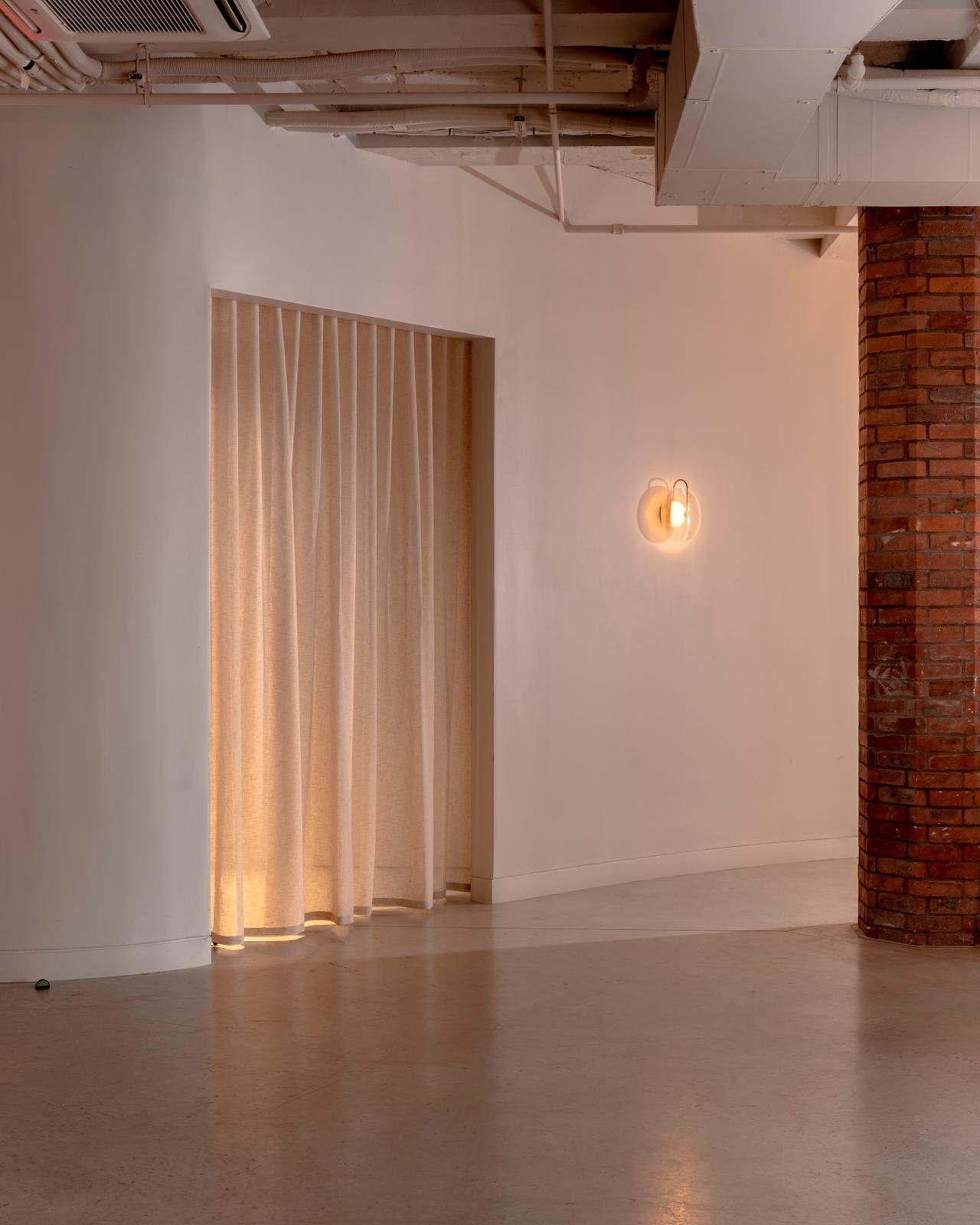 Curved hallway with sconce lighting