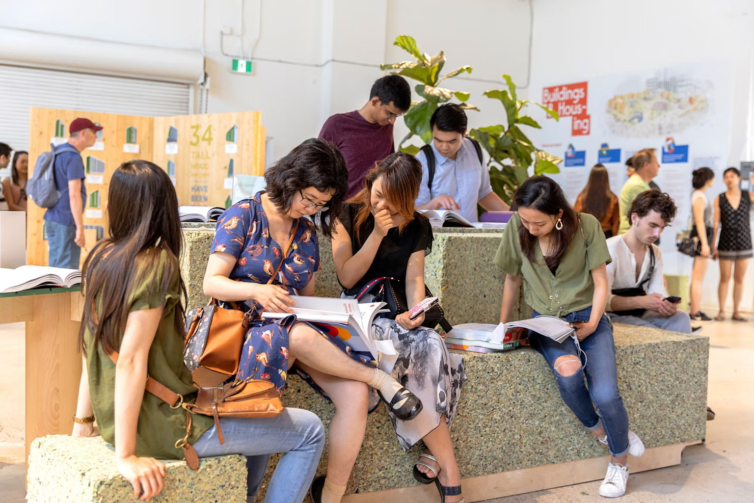 Visitors reading the printed volumes at the exhibition