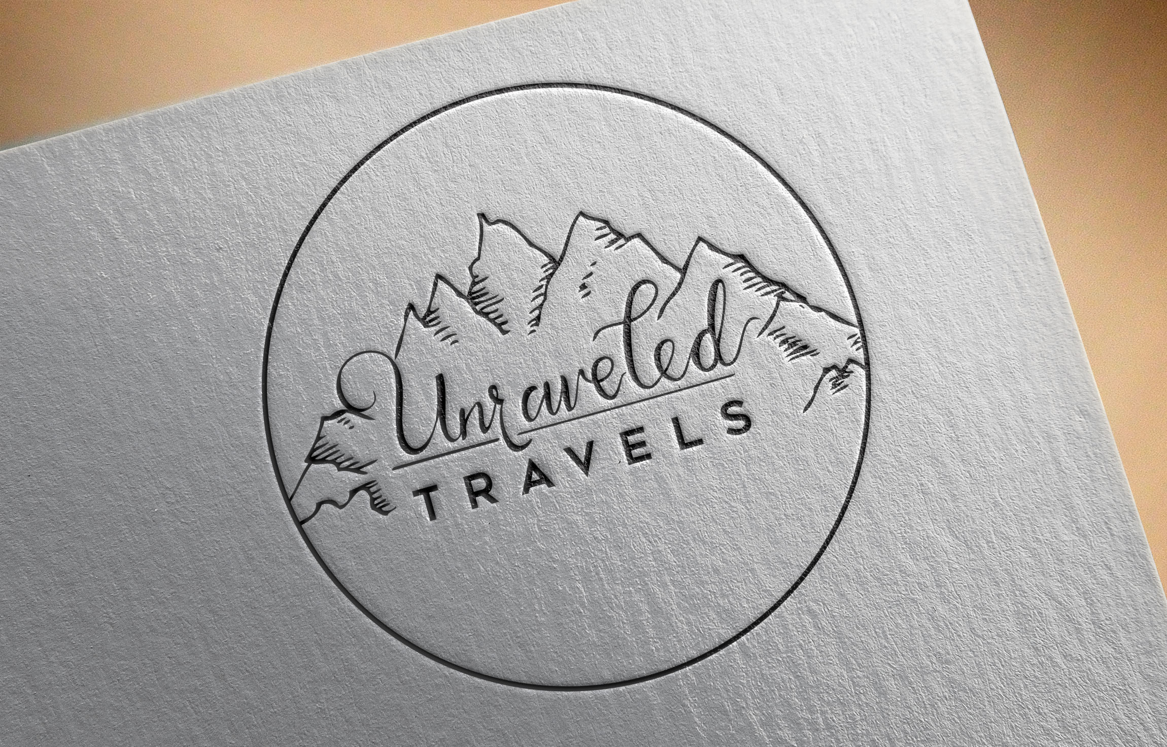Unraveled Travels logo letterpressed on textured paper